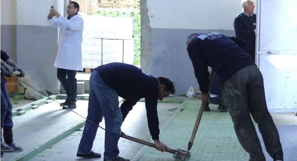 Craftsmen stamping the soap bars by hand