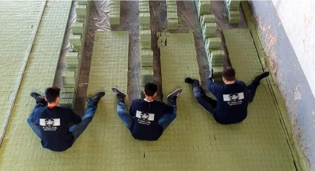 Workers arranging cut soap bars into rows